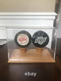 Wayne Gretzky and Gordie Howe Autographed Pucks, display case And COA