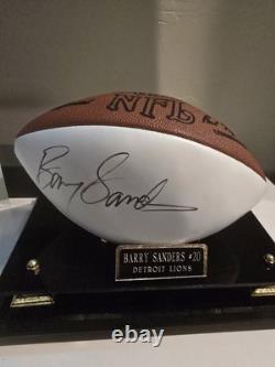 Ballon de football NFL officiel autographed par Barry Sanders avec vitrine en verre et certificat d'authenticité.